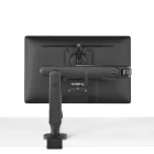 Achteraanzicht van een strakke zwarte monitor op een Herman Miller Ollin Monitor Arm, bevestigd op een plat oppervlak tegen een witte achtergrond, die verstelbare positionering en ergonomisch comfort biedt.